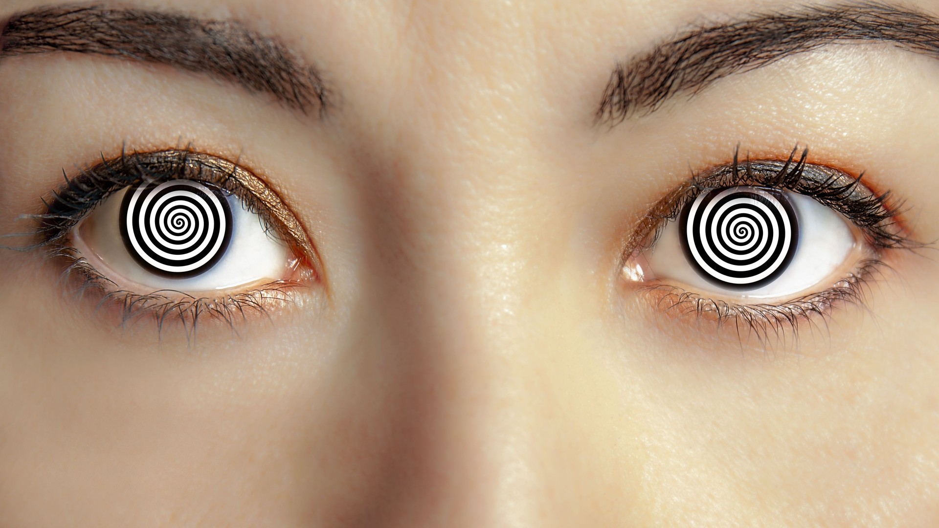 closeup woman face with hypnotized eyes